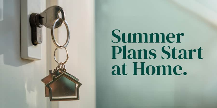 Up-close view of a key hanging from a door lock to a home. At the left, the words: summer plans start at home