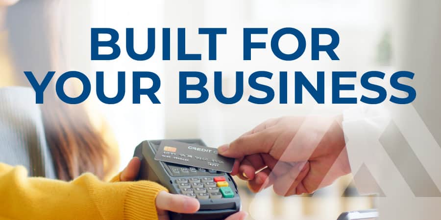 A hand holding a credit card and making a payment. The words across the middle: built for your business.