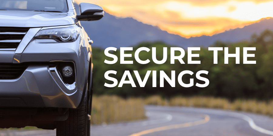 Front view of a silver SUV parked along a scenic mountain road at sunset. At the right, the words: secure the savings.