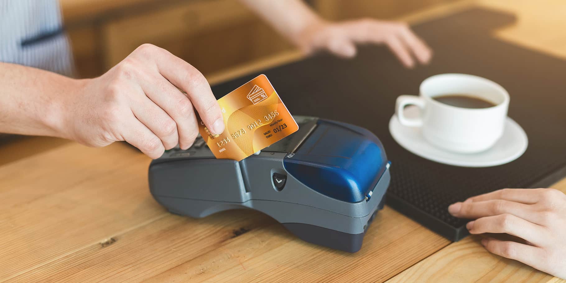 A credit card machine accepting a credit card.