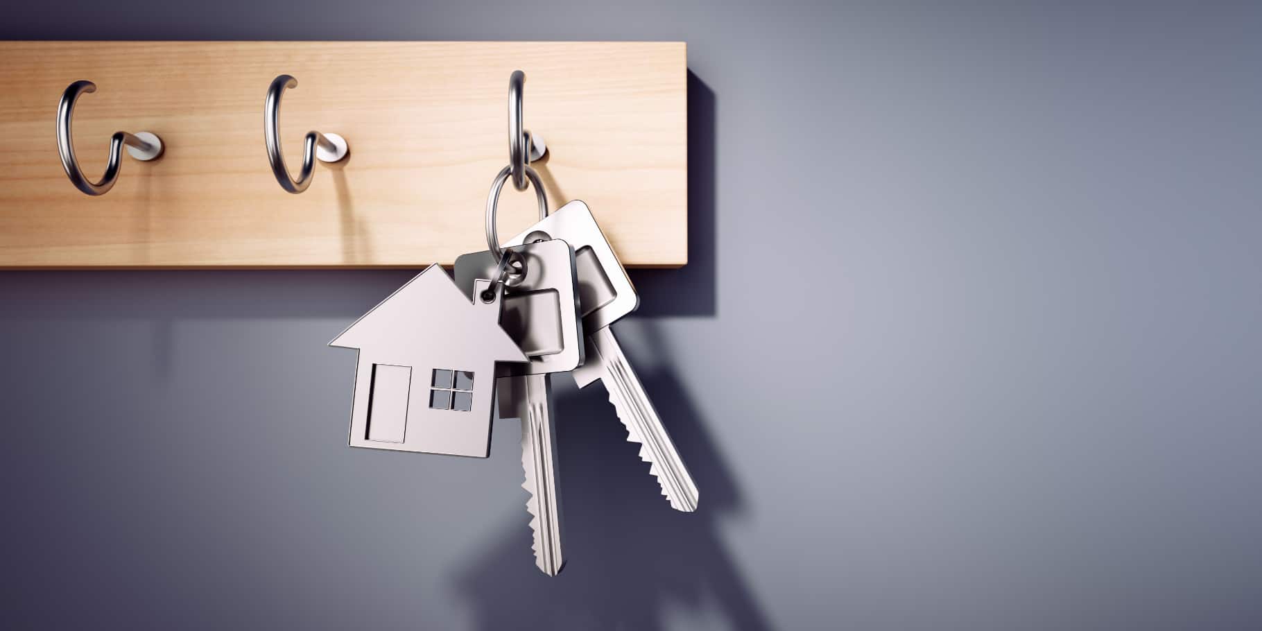 Keys hanging on a coat hanging rack.