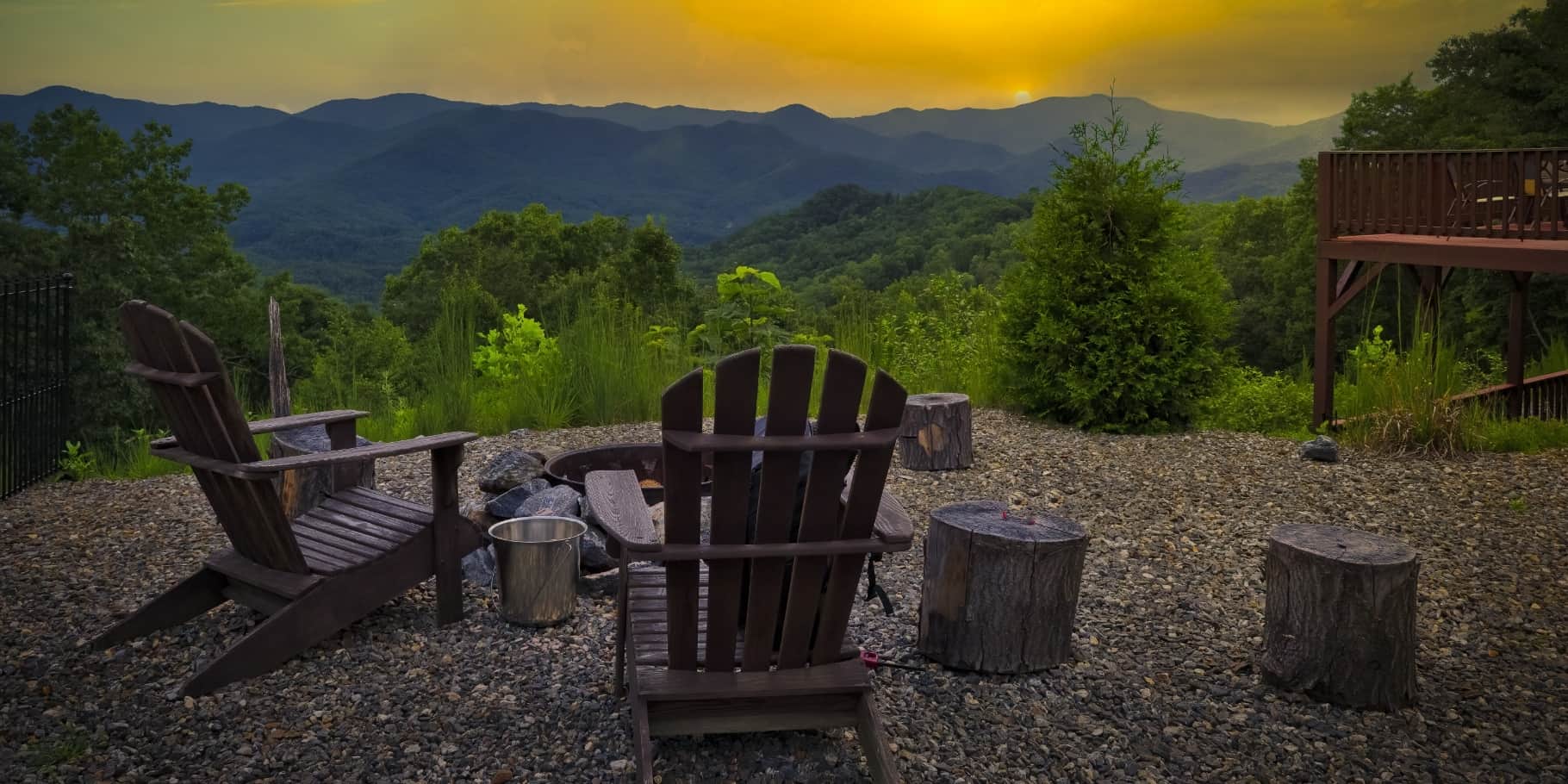 Adirondack chairs around a firepit overlooking the blue ridge mountains.