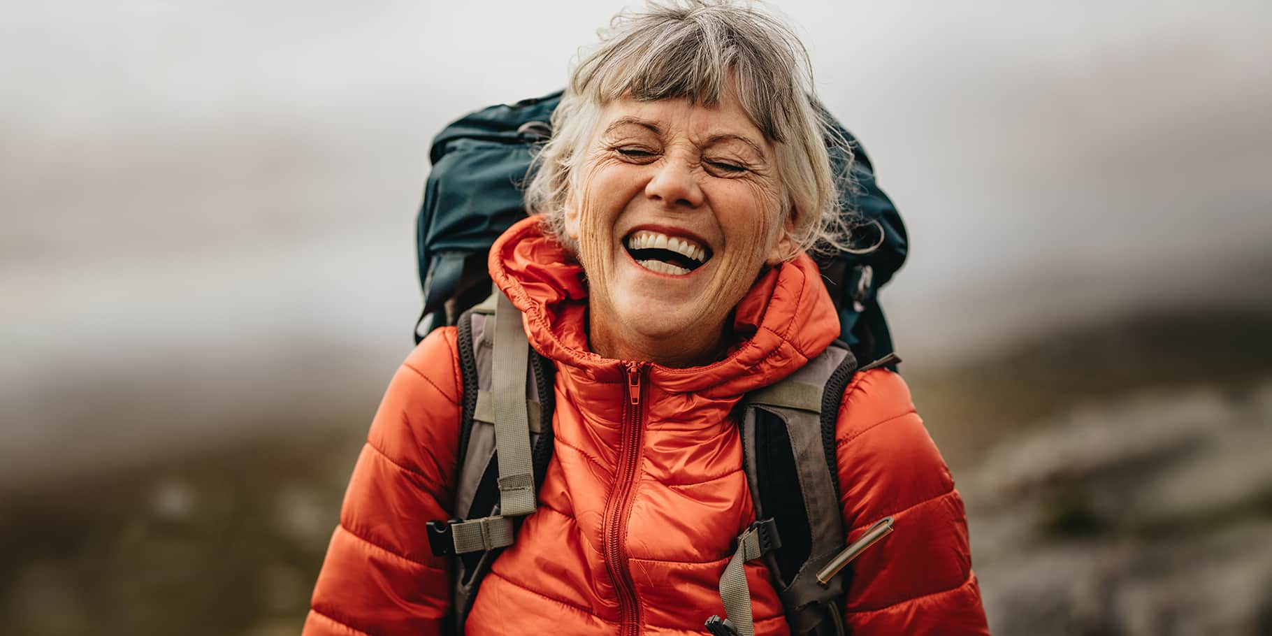 A smiling senior woman on a hike.